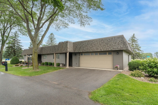 102 Terrace Vw E, Decoria Twp, MN 56001 - view of front of home featuring roof with shingles, a garage, mansard roof, a front lawn, and driveway