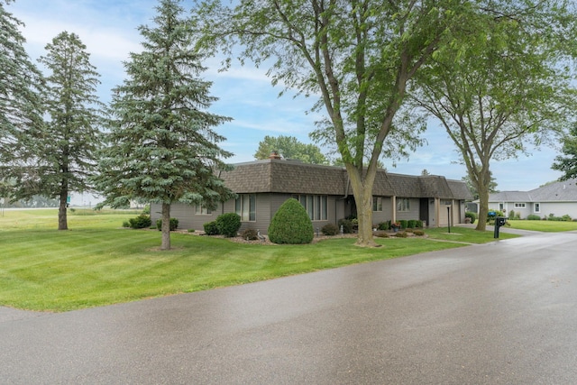 102 Terrace Vw E, Decoria Twp, MN 56001 - view of front of property featuring roof with shingles, mansard roof, and a front yard