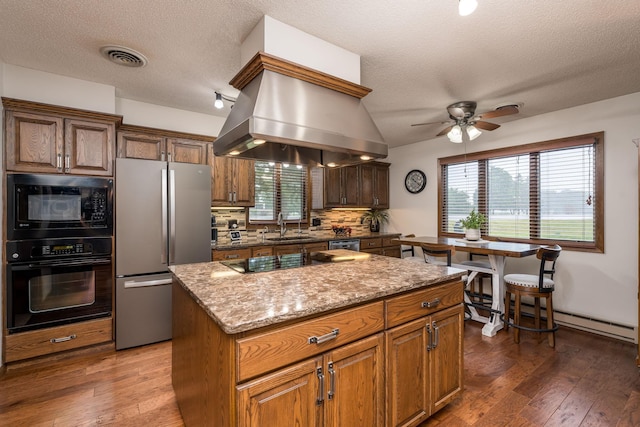 102 Terrace Vw E, Decoria Twp, MN 56001 - kitchen with black appliances, a ceiling fan, backsplash, hardwood / wood-style flooring, and a textured ceiling