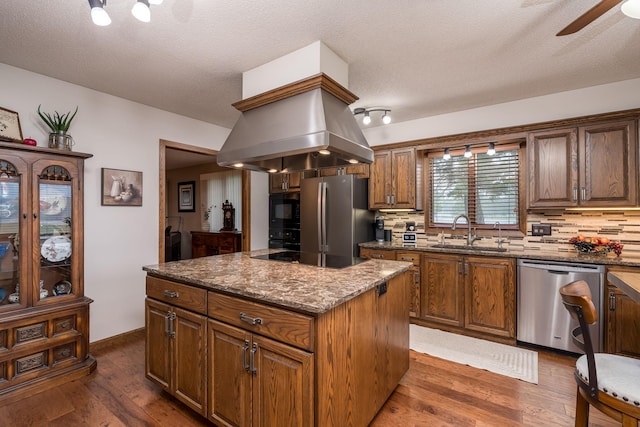 102 Terrace Vw E, Decoria Twp, MN 56001 - kitchen featuring black appliances, decorative backsplash, a ceiling fan, a kitchen island, and a textured ceiling