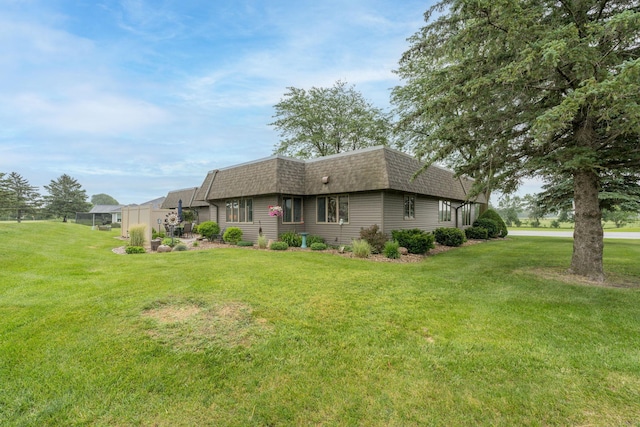 102 Terrace Vw E, Decoria Twp, MN 56001 - rear view of house featuring mansard roof, a shingled roof, and a lawn