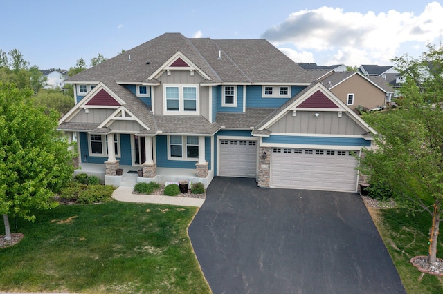 6430 Bluestem Cir, Corcoran, MN 55340 - craftsman-style home featuring board and batten siding, driveway, roof with shingles, stone siding, and a porch