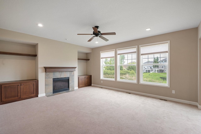 6430 Bluestem Cir, Corcoran, MN 55340 - unfurnished living room featuring light carpet, a tile fireplace, ceiling fan, and recessed lighting