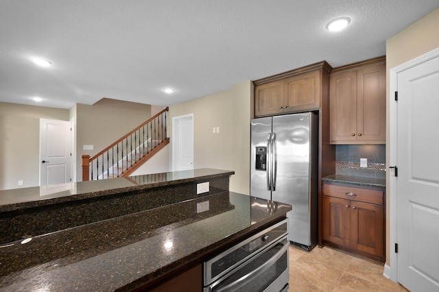 6430 Bluestem Cir, Corcoran, MN 55340 - kitchen with appliances with stainless steel finishes, dark stone countertops, and recessed lighting