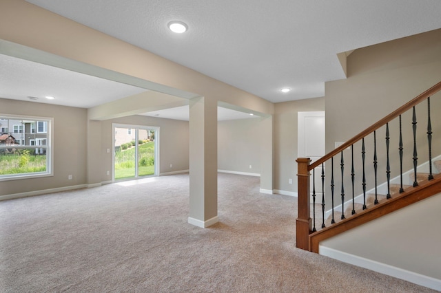 6430 Bluestem Cir, Corcoran, MN 55340 - unfurnished living room with carpet floors, stairs, and recessed lighting