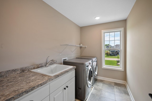 6430 Bluestem Cir, Corcoran, MN 55340 - washroom featuring separate washer and dryer, cabinet space, and light stone finish floors