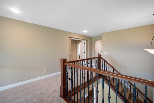 6430 Bluestem Cir, Corcoran, MN 55340 - hallway featuring an upstairs landing, arched walkways, carpet flooring, and recessed lighting
