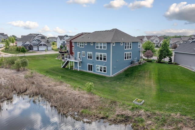 6430 Bluestem Cir, Corcoran, MN 55340 - back of house with a residential view, a yard, stairway, and a water view