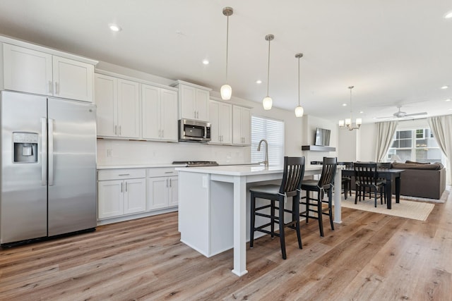 6645 Jody Ave S, Cottage Grove, MN 55016 - kitchen featuring appliances with stainless steel finishes, plenty of natural light, light wood-style floors, and recessed lighting