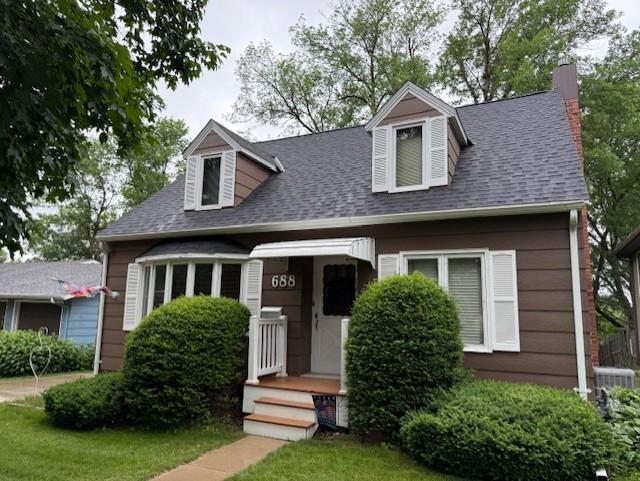 688 Miller Ave, Windom, MN 56101 - cape cod home featuring roof with shingles and a chimney