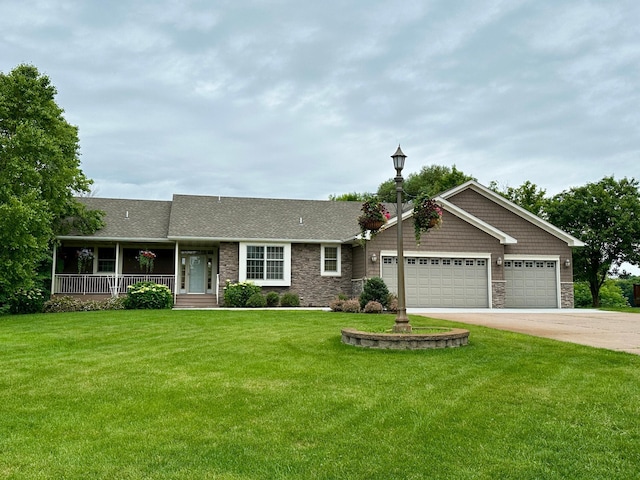 7350 233rd St N, Forest Lake, MN 55025 - view of front of home with stone siding, a garage, a front lawn, driveway, and covered porch