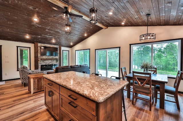 19566 Early Bird Dr, Park Rapids, MN 56470 - kitchen featuring wooden ceiling, plenty of natural light, a stone fireplace, lofted ceiling, and light wood-style flooring