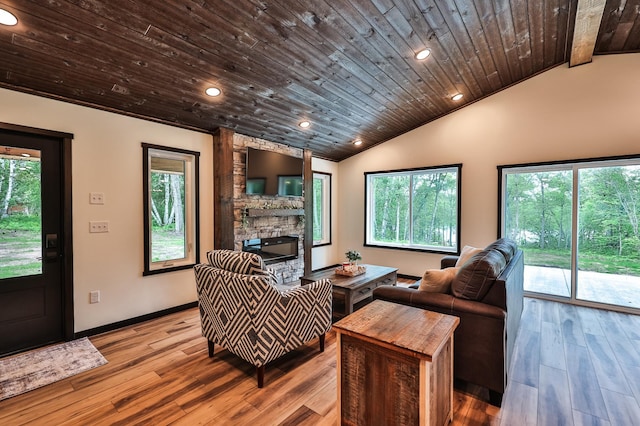 19566 Early Bird Dr, Park Rapids, MN 56470 - living room featuring a stone fireplace, vaulted ceiling, wooden ceiling, wood finished floors, and recessed lighting