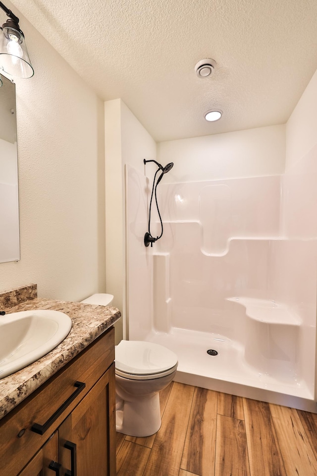 19566 Early Bird Dr, Park Rapids, MN 56470 - full bath with a shower, wood finished floors, a textured ceiling, and vanity