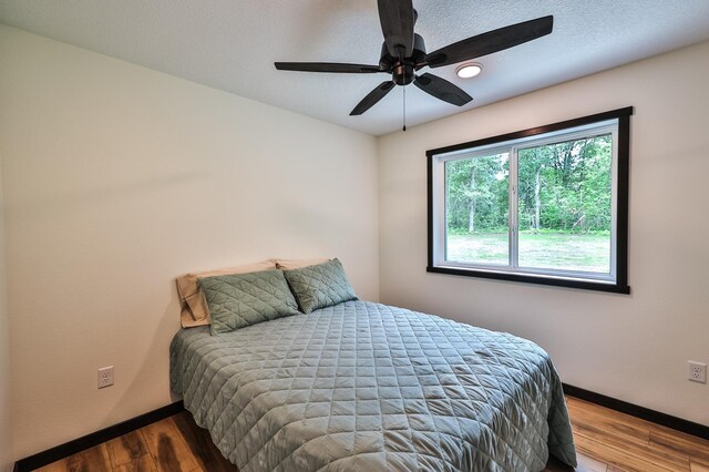 19566 Early Bird Dr, Park Rapids, MN 56470 - bedroom with wood finished floors and ceiling fan