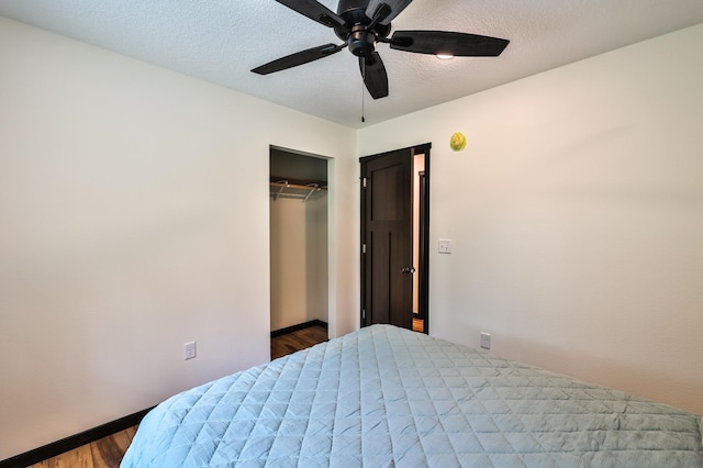 19566 Early Bird Dr, Park Rapids, MN 56470 - bedroom with wood finished floors, a closet, ceiling fan, and a textured ceiling
