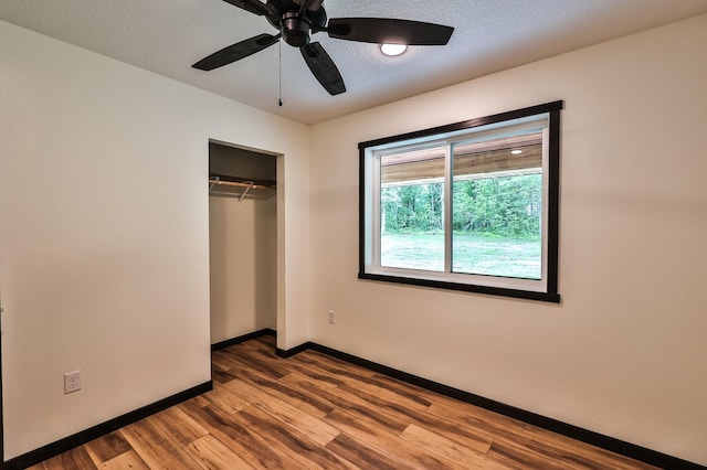 19566 Early Bird Dr, Park Rapids, MN 56470 - unfurnished bedroom with wood finished floors, a closet, and a ceiling fan