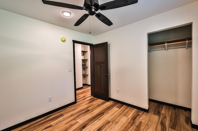 19566 Early Bird Dr, Park Rapids, MN 56470 - unfurnished bedroom featuring wood finished floors, a closet, ceiling fan, and a textured ceiling
