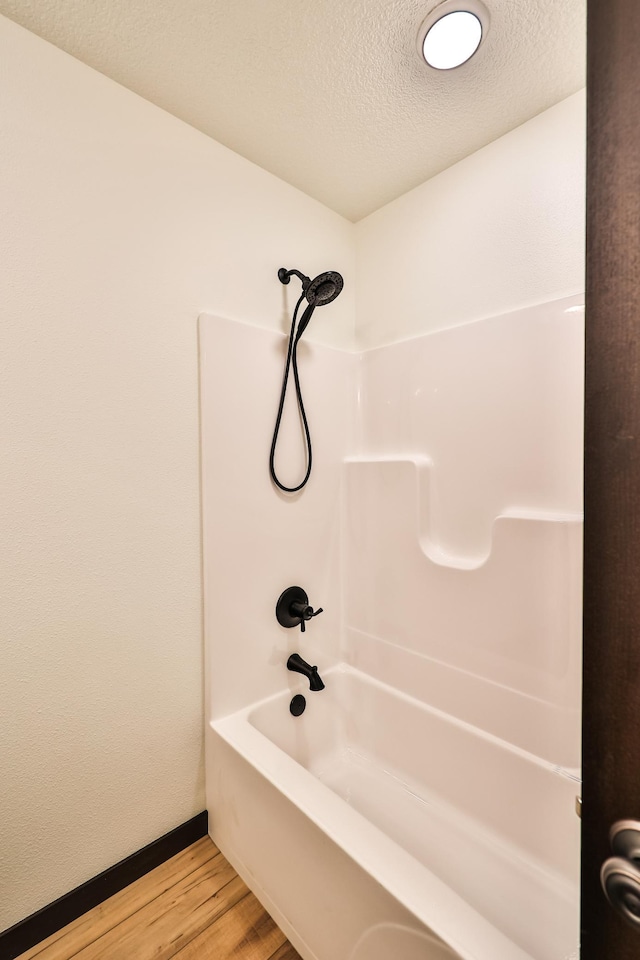 19566 Early Bird Dr, Park Rapids, MN 56470 - full bath with wood finished floors, a textured ceiling, and shower / bath combination