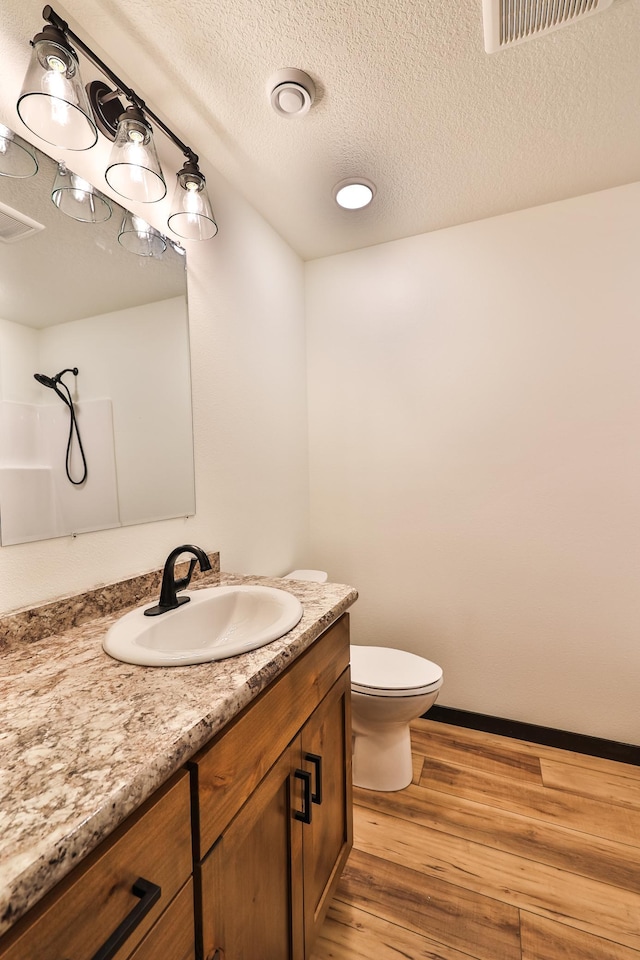 19566 Early Bird Dr, Park Rapids, MN 56470 - bathroom with vanity, wood finished floors, and a textured ceiling