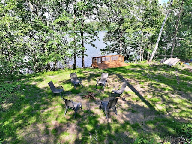 19566 Early Bird Dr, Park Rapids, MN 56470 - view of yard with an outdoor fire pit and a deck with water view