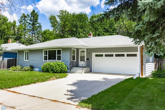 420 17th St S, Moorhead, MN 56560 - ranch-style home with an attached garage, concrete driveway, and a chimney