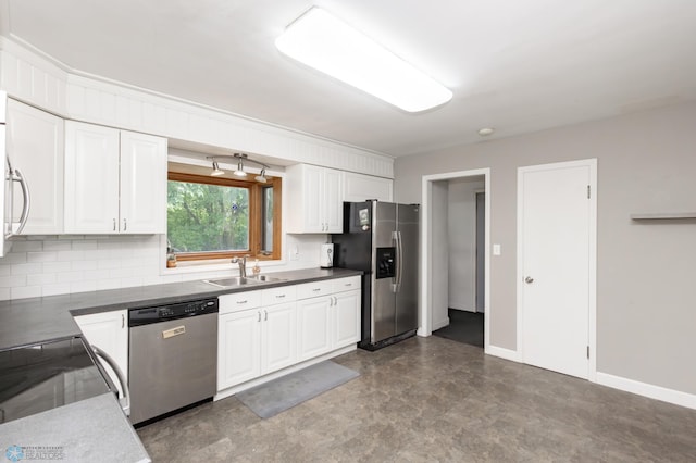 420 17th St S, Moorhead, MN 56560 - kitchen with stainless steel appliances, white cabinetry, decorative backsplash, dark flooring, and dark countertops