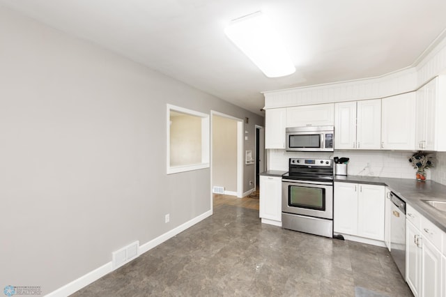 420 17th St S, Moorhead, MN 56560 - kitchen with appliances with stainless steel finishes, backsplash, and white cabinetry