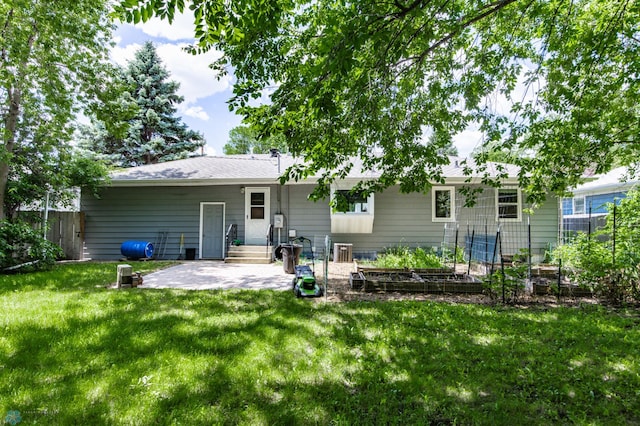 420 17th St S, Moorhead, MN 56560 - rear view of property with a patio area and a vegetable garden