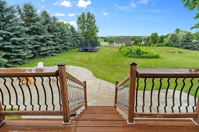 876 162nd St, Hammond, WI 54015 - wooden terrace featuring a trampoline, a lawn, and a patio area