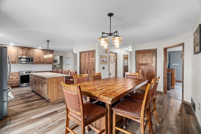 876 162nd St, Hammond, WI 54015 - dining room featuring wood finished floors and a chandelier