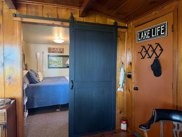 21393 324th Pl, Lakeside Twp, MN 56342 - bedroom featuring a barn door, carpet floors, wood walls, and vaulted ceiling