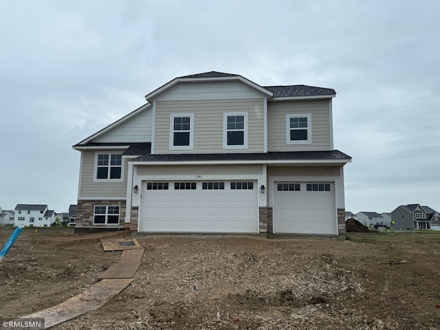 2740 Ivory Ave NE, Saint Michael, MN 55376 - view of front of home featuring stone siding, a garage, a shingled roof, and driveway