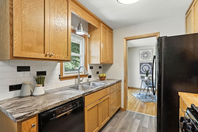 11439 Heights Dr NW, Coon Rapids, MN 55433 - kitchen featuring black appliances, light wood-style floors, and backsplash