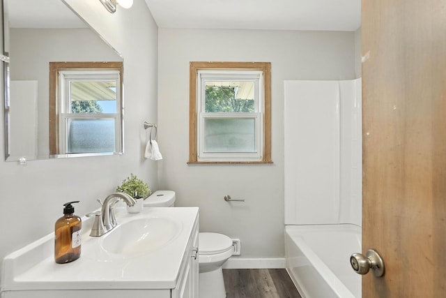 11439 Heights Dr NW, Coon Rapids, MN 55433 - full bath featuring vanity, healthy amount of natural light, and wood finished floors