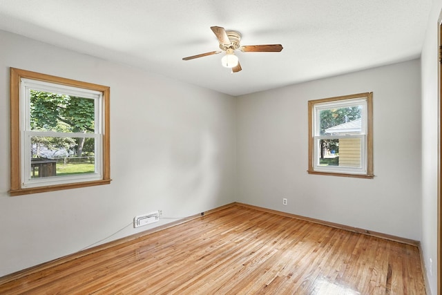 11439 Heights Dr NW, Coon Rapids, MN 55433 - spare room featuring light wood finished floors and a ceiling fan