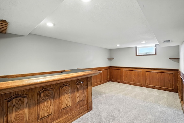 11439 Heights Dr NW, Coon Rapids, MN 55433 - indoor dry bar featuring light colored carpet, wainscoting, and recessed lighting