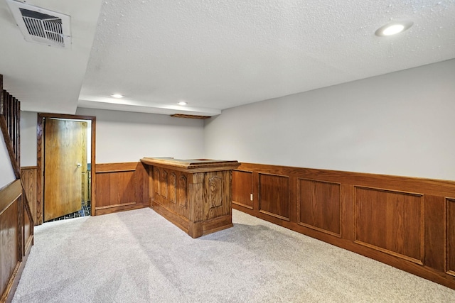 11439 Heights Dr NW, Coon Rapids, MN 55433 - indoor dry bar with light colored carpet, wainscoting, recessed lighting, a textured ceiling, and wood walls