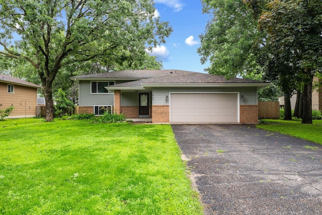 11460 Goldenrod St NW, Coon Rapids, MN 55448 - tri-level home featuring brick siding, asphalt driveway, and an attached garage