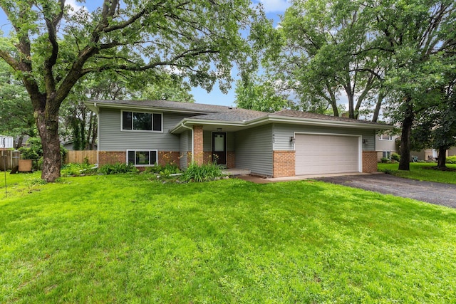 11460 Goldenrod St NW, Coon Rapids, MN 55448 - split level home with brick siding, asphalt driveway, and a garage