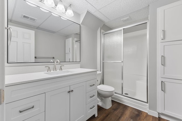 11460 Goldenrod St NW, Coon Rapids, MN 55448 - bathroom featuring a paneled ceiling, a shower stall, vanity, and wood finished floors