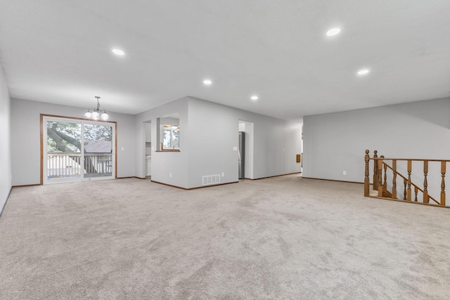 11460 Goldenrod St NW, Coon Rapids, MN 55448 - unfurnished living room with a chandelier, recessed lighting, and light carpet