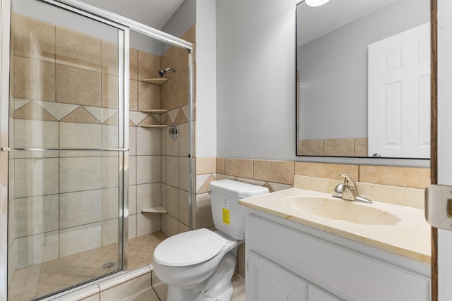11460 Goldenrod St NW, Coon Rapids, MN 55448 - full bathroom featuring vanity, a stall shower, tile walls, and wainscoting