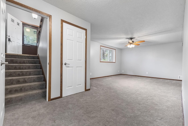 11460 Goldenrod St NW, Coon Rapids, MN 55448 - interior space featuring carpet floors, a textured ceiling, a ceiling fan, and stairs