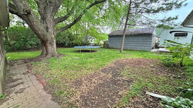 122 Plainview Ave, Mankato, MN 56001 - view of grassy yard featuring a trampoline and a storage unit