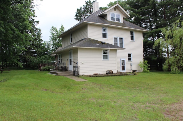 34497 Quiken Rd, Motley, MN 56466 - back of house featuring a chimney, a yard, and a shingled roof