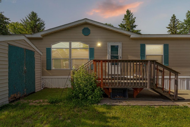 108 Hilton Ct, Mankato, MN 56001 - back of house at dusk with a lawn and a deck