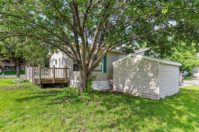 108 Hilton Ct, Mankato, MN 56001 - back of house featuring a deck, a storage unit, and a lawn