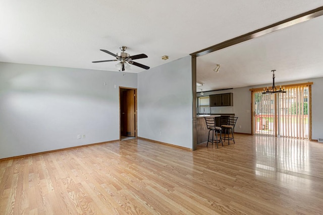 108 Hilton Ct, Mankato, MN 56001 - living room with light wood-style flooring, ceiling fan, and a chandelier