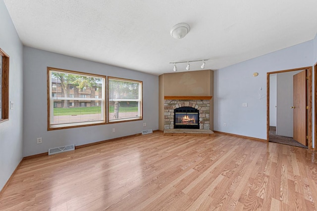 108 Hilton Ct, Mankato, MN 56001 - unfurnished living room featuring light wood finished floors and a fireplace